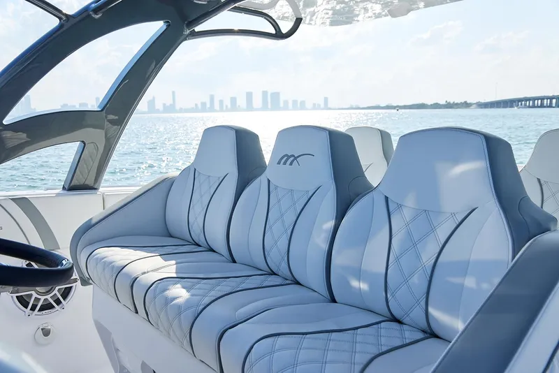 Slide: The Image of Luxurious seating on a 2021 Midnight Express 43' Open boat with city skyline view. - 13