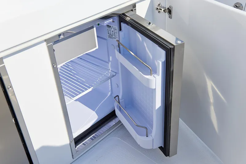 Slide: The Image of Open refrigerator on 2021 Midnight Express 43' Open boat, showcasing interior shelves. - 16