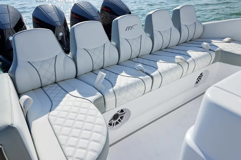 Slide: The Image of Luxurious seating on 2021 Midnight Express 43' Open boat with powerful engines in background. - 18