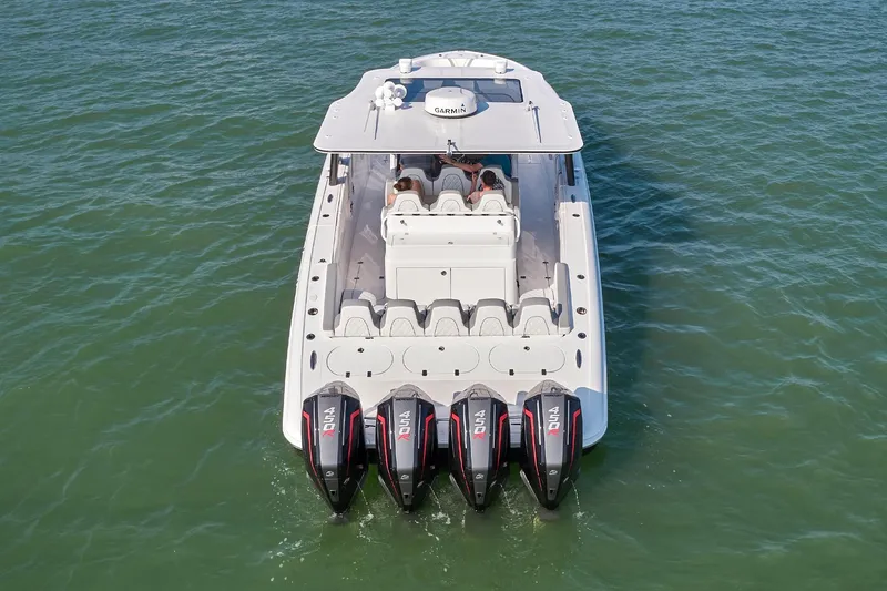 Slide: The Image of 2021 Midnight Express 43' Open boat with four powerful outboard engines on the water. - 7