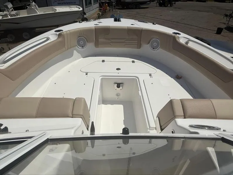 Slide: The Image of 2025 Edgewater 248CX boat interior with beige seating and storage compartment. - 5