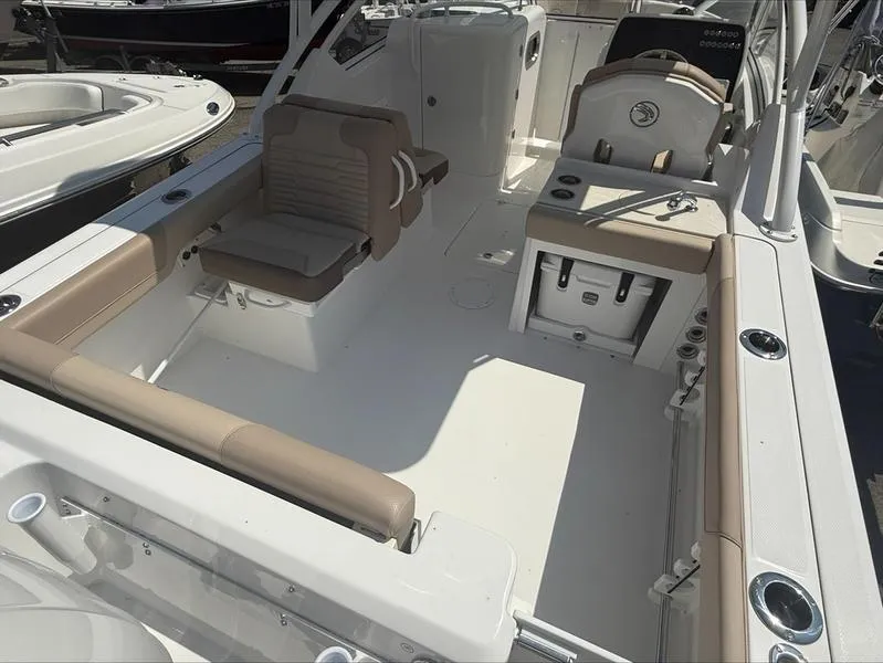 Slide: The Image of 2025 Edgewater 248CX boat interior with beige seating and modern design. - 9