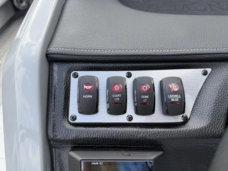 Slide: The Image of Control panel of 2025 Godfrey Monaco 235 SFL boat with labeled switches. - 12