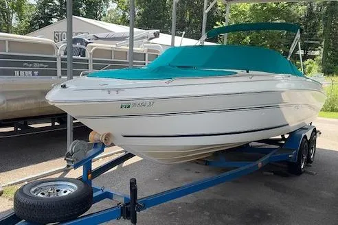 The Image of 1998 Sea Ray 210 Signature boat on trailer, covered with teal canopy, parked outdoors. - 1