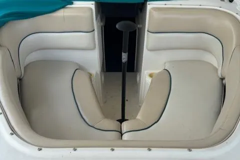 Slide: The Image of 1998 Sea Ray 210 Signature boat interior with white cushioned seating. - 13