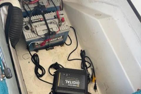 Slide: The Image of Battery and charger setup in 1998 Sea Ray 210 Signature boat compartment. - 15
