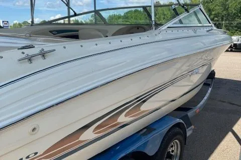 Slide: The Image of 1998 Sea Ray 210 Signature boat on trailer, side view, outdoors. - 4