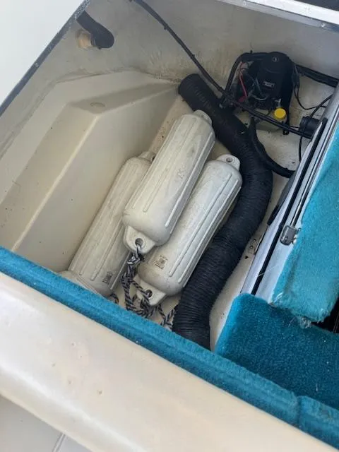 Slide: The Image of Storage compartment of a 1998 Sea Ray 210 Signature boat with fenders and equipment. - 7