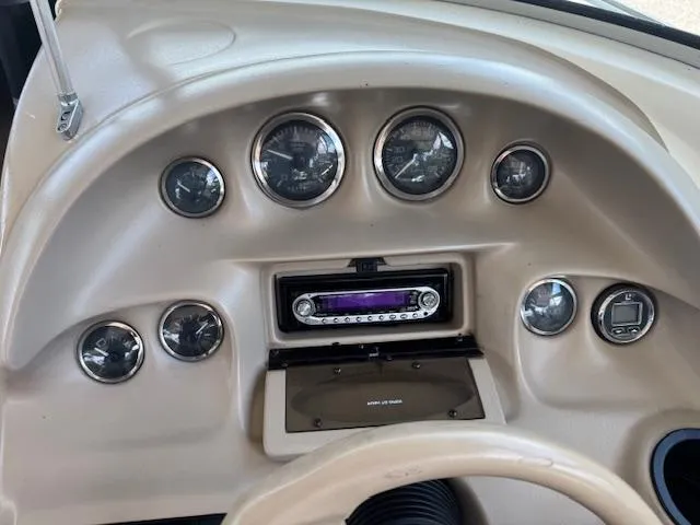 Slide: The Image of Dashboard of a 1998 Sea Ray 210 Signature boat with gauges and stereo system. - 9
