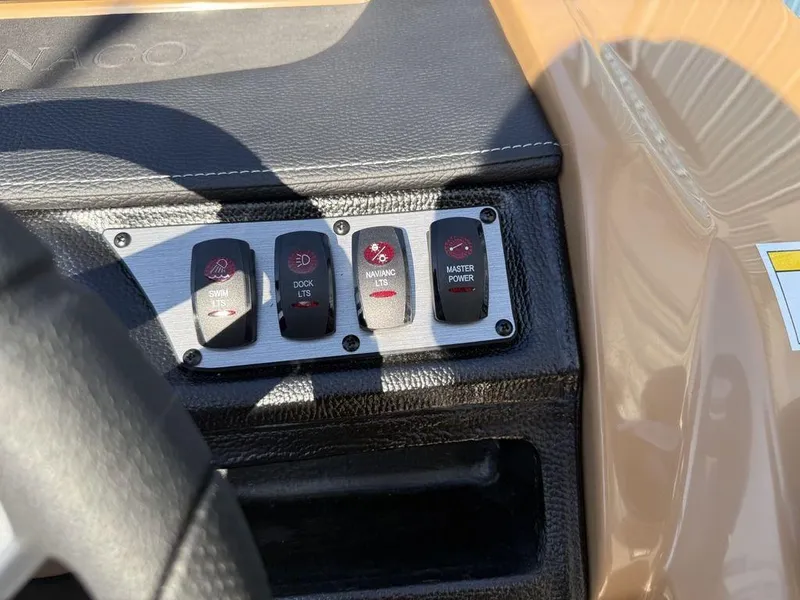 Slide: The Image of Control panel of 2025 Godfrey Monaco 235 SFL boat with labeled switches. - 13