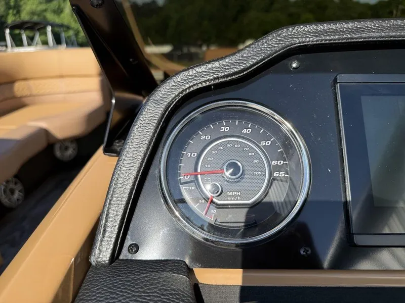 Slide: The Image of Speedometer of 2025 Godfrey Monaco 235 SFL iMPACT pontoon boat, with tan seating in background. - 15