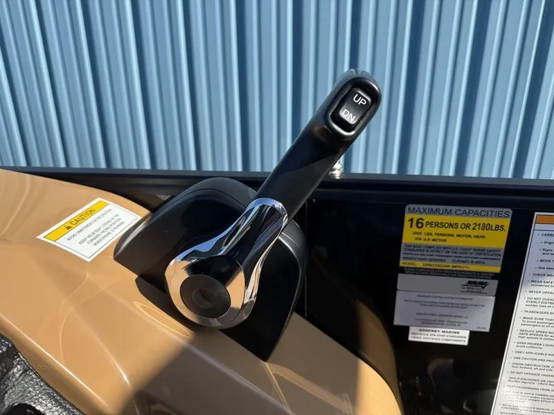 Slide: The Image of Throttle control lever on 2025 Godfrey Monaco 235 SFL iMPACT boat, with capacity label. - 16