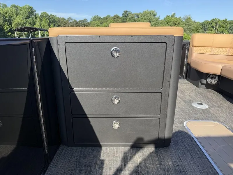 Slide: The Image of Storage drawers on 2025 Godfrey Monaco 235 SFL iMPACT pontoon boat, featuring tan seating. - 21