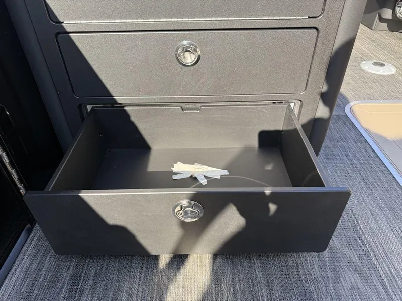Slide: The Image of Open drawer in 2025 Godfrey Monaco 235 SFL iMPACT boat, showing interior storage space. - 22