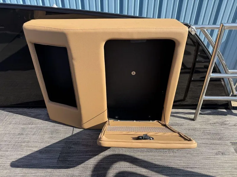 Slide: The Image of 2025 Godfrey Monaco 235 SFL iMPACT Package storage compartment with open hatch, beige upholstery. - 23