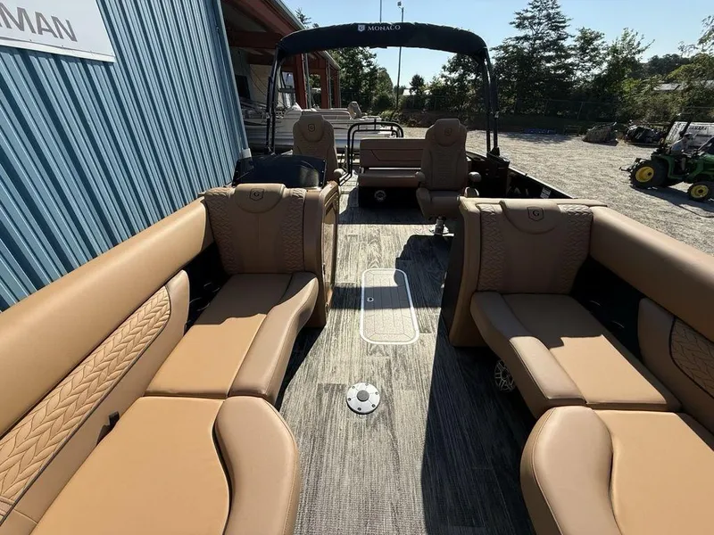 Slide: The Image of 2025 Godfrey Monaco 235 SFL iMPACT pontoon boat with luxurious tan seating and spacious layout. - 30