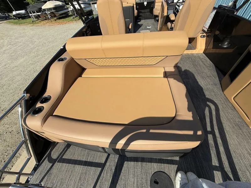 Slide: The Image of 2025 Godfrey Monaco 235 SFL iMPACT boat with tan seating and cup holders. - 31