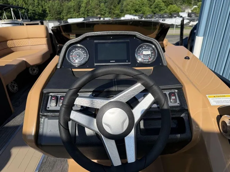 Slide: The Image of 2025 Godfrey Monaco 235 SFL iMPACT boat dashboard with steering wheel and gauges. - 7