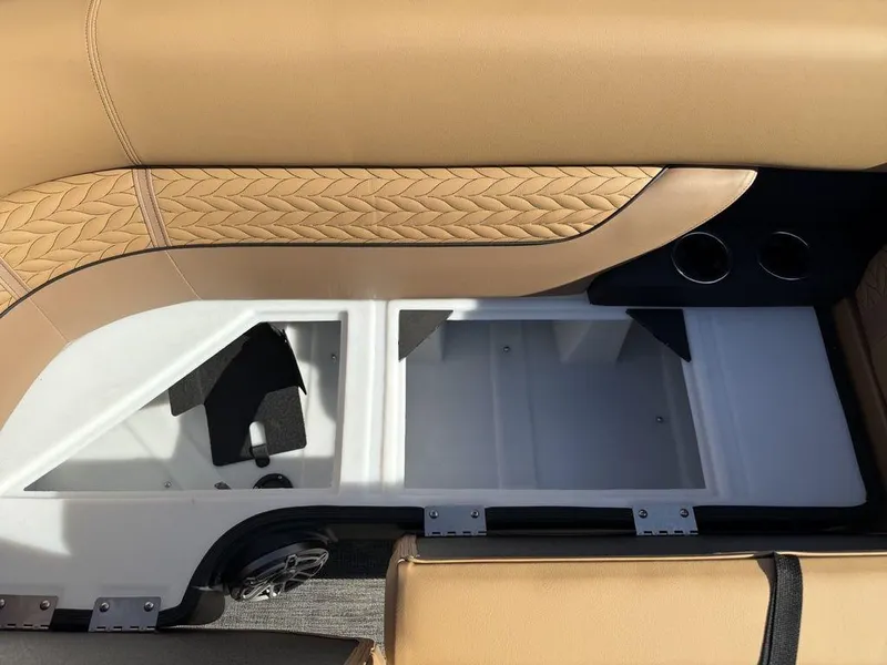 Slide: The Image of 2025 Godfrey Monaco 235 SFL iMPACT boat interior storage compartment with tan upholstery. - 8