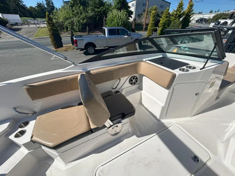Slide: The Image of 2021 Sea Ray 21 SPX OB boat interior with tan seating and windshield. - 9