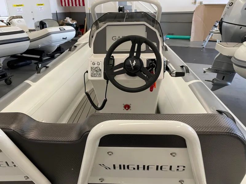 Slide: The Image of 2024 Highfield Sport 390 boat interior with steering wheel and control panel. - 4