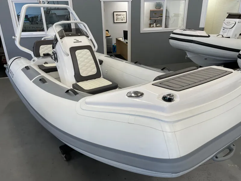 Slide: The Image of 2024 Highfield Sport 390 inflatable boat in showroom, featuring sleek design and comfortable seating. - 5