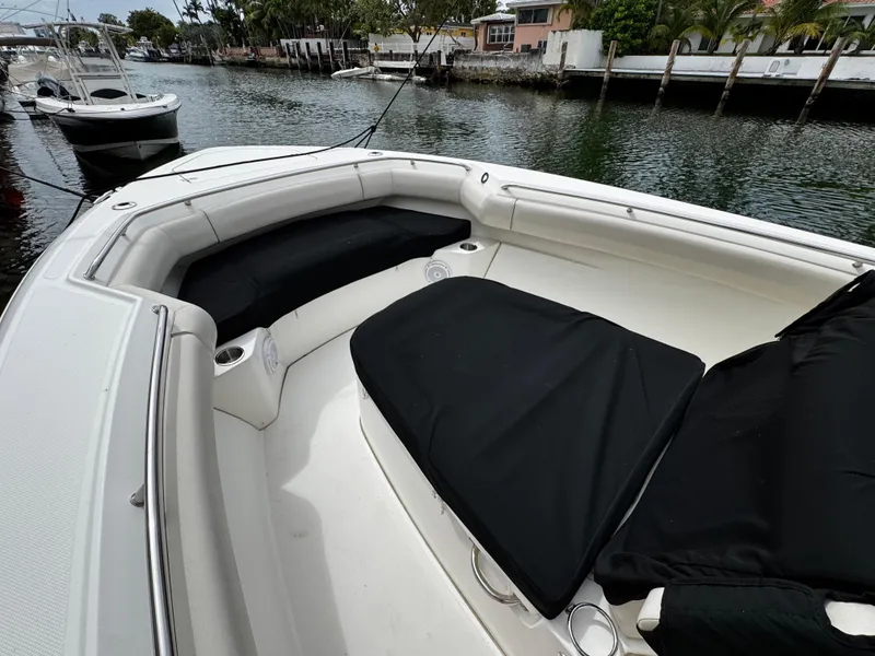 Slide: The Image of 2020 Boston Whaler 280 Outrage boat interior with cushioned seating and cup holders. - 10