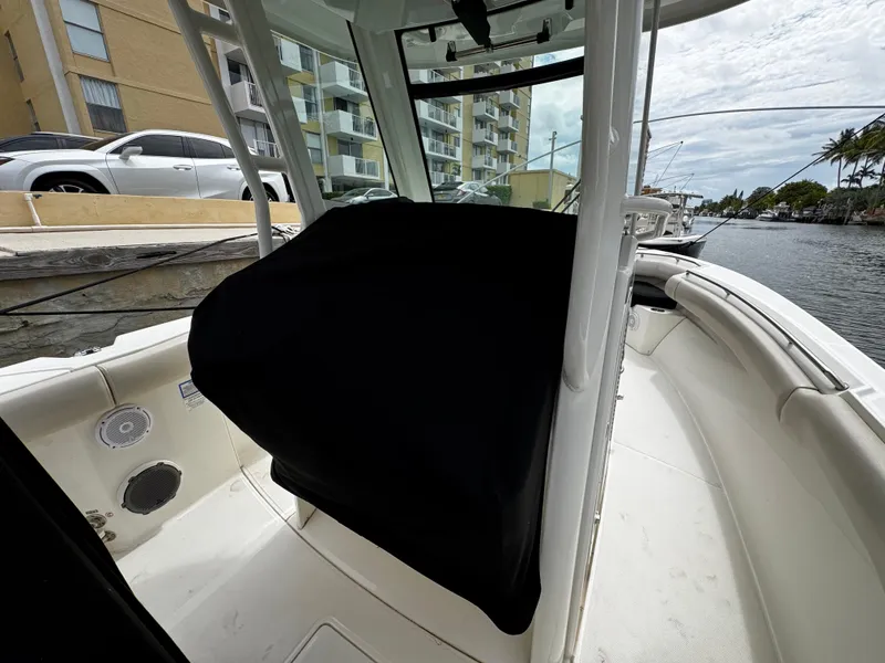 Slide: The Image of 2020 Boston Whaler 280 Outrage boat interior, docked near waterfront buildings. - 11