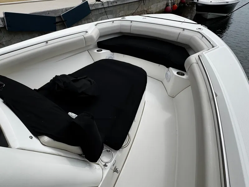 Slide: The Image of 2020 Boston Whaler 280 Outrage boat interior with cushioned seating and cup holders. - 12