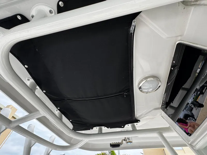Slide: The Image of 2020 Boston Whaler 280 Outrage boat interior, featuring a black canopy and sleek design elements. - 13