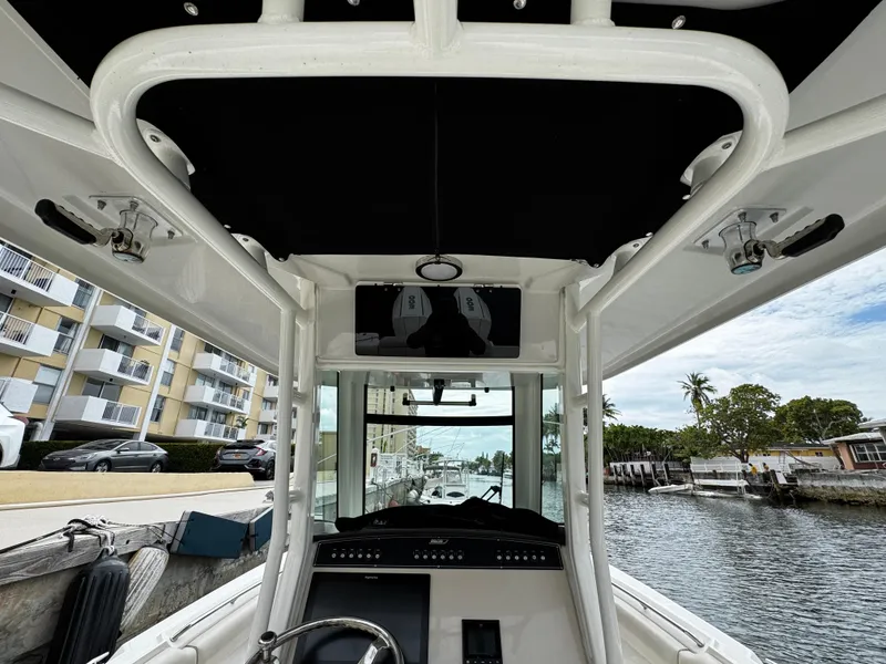 Slide: The Image of Interior view of 2020 Boston Whaler 280 Outrage boat, docked near waterfront buildings. - 14