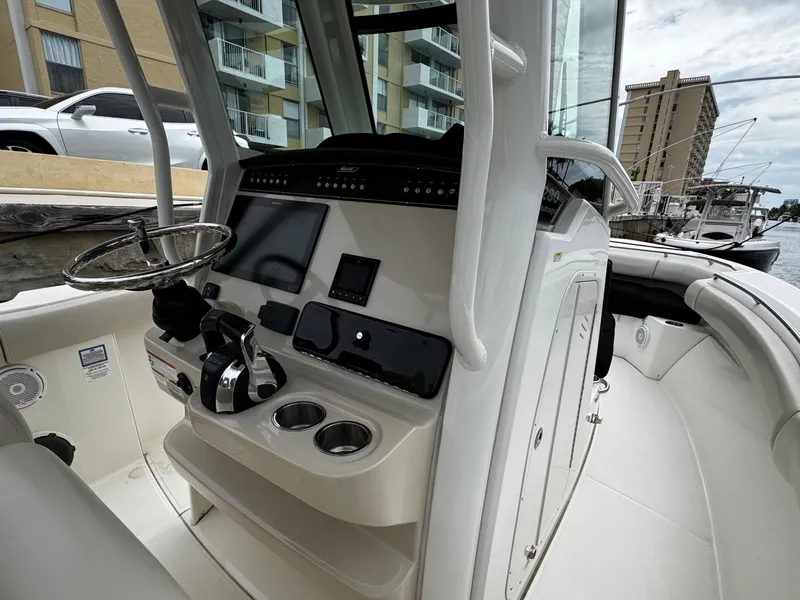 Slide: The Image of 2020 Boston Whaler 280 Outrage boat cockpit with steering wheel and control panel. - 15