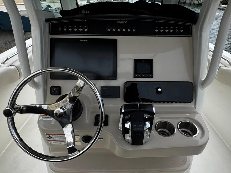 Slide: The Image of 2020 Boston Whaler 280 Outrage helm with steering wheel and control panel. - 17
