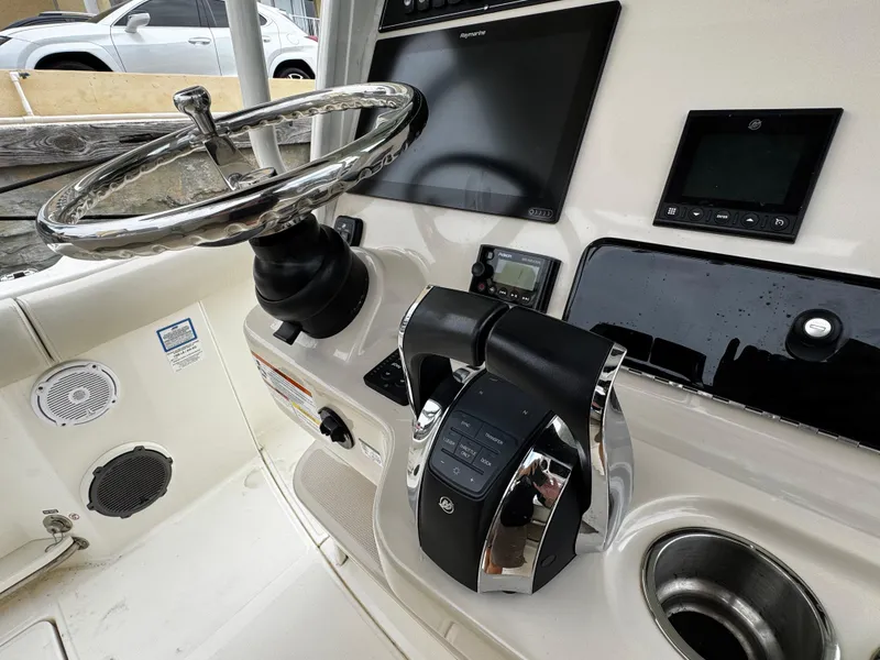 Slide: The Image of Control panel of a 2020 Boston Whaler 280 Outrage boat with steering wheel and electronics. - 19
