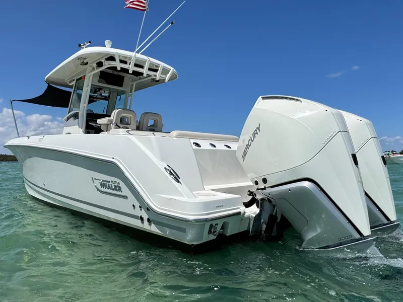 Slide: The Image of 2020 Boston Whaler 280 Outrage boat with dual Mercury engines on clear water. - 2