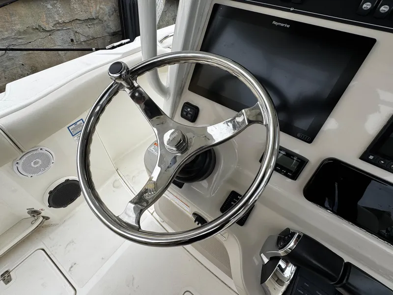 Slide: The Image of Steering wheel and controls of a 2020 Boston Whaler 280 Outrage boat. - 20