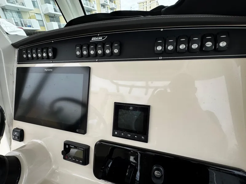 Slide: The Image of Control panel of a 2020 Boston Whaler 280 Outrage boat with navigation screens. - 21