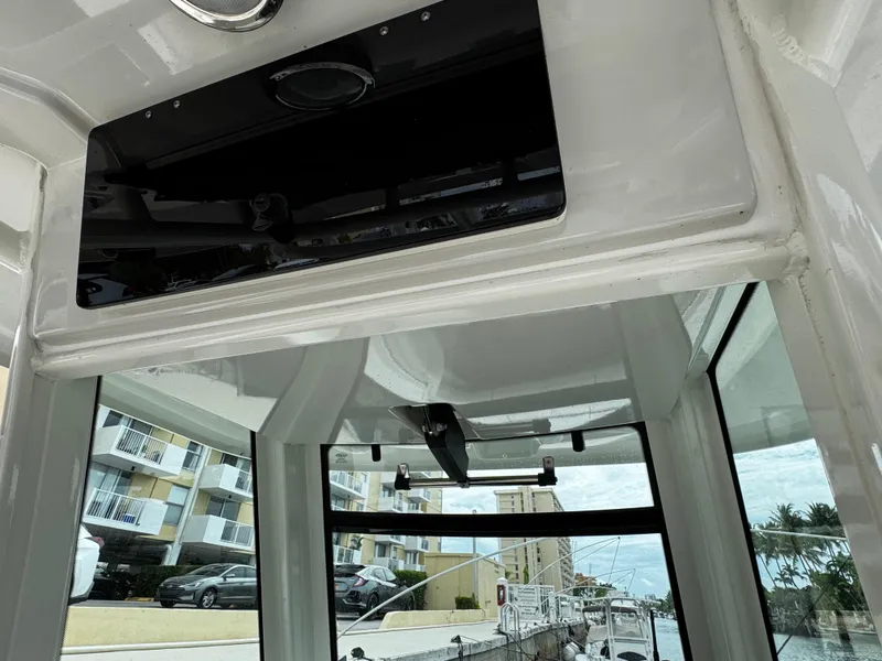 Slide: The Image of Interior view of a 2020 Boston Whaler 280 Outrage boat, showcasing windows and ceiling details. - 24
