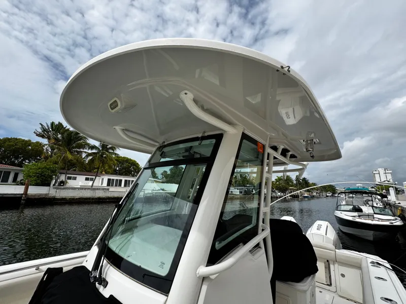 Slide: The Image of 2020 Boston Whaler 280 Outrage boat docked, featuring sleek design and spacious deck. - 26