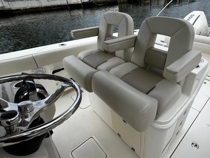 Slide: The Image of 2020 Boston Whaler 280 Outrage helm seating with dual chairs and steering wheel. - 27