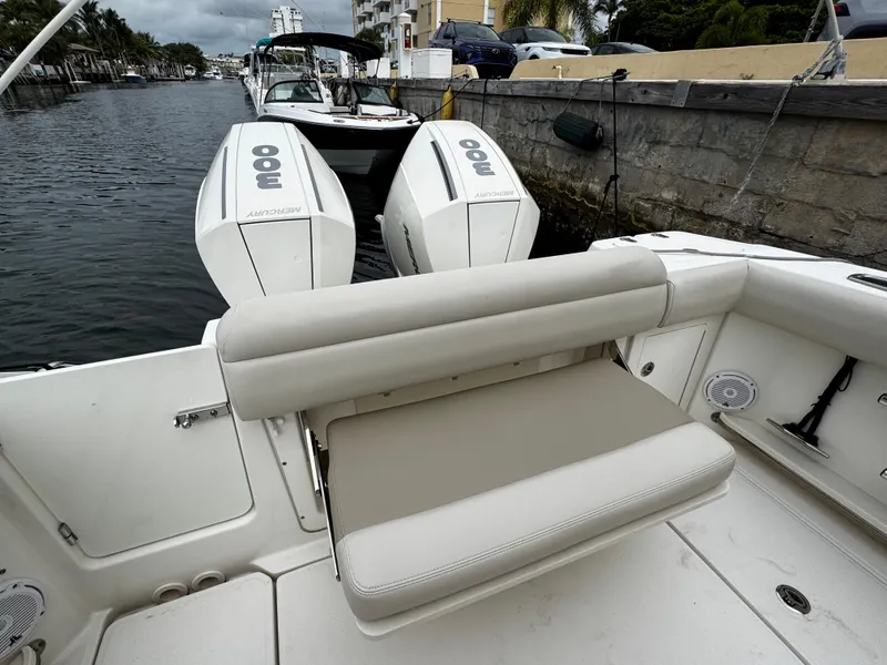 Slide: The Image of 2020 Boston Whaler 280 Outrage with dual Mercury engines, docked by a canal. - 30