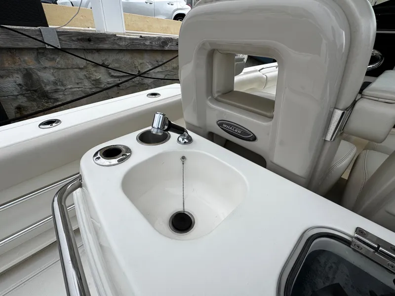 Slide: The Image of Boston Whaler 280 Outrage 2020 boat interior with sink and seating area. - 32