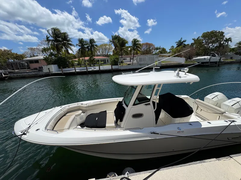 Slide: The Image of 2020 Boston Whaler 280 Outrage boat docked by a scenic waterfront. - 5