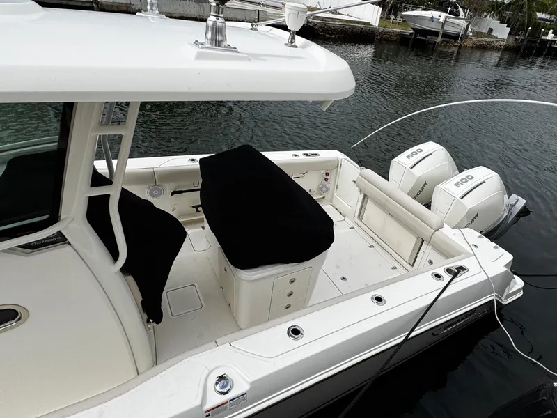 Slide: The Image of 2020 Boston Whaler 280 Outrage boat with dual Mercury engines docked by the water. - 7