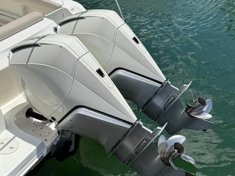 Slide: The Image of Twin outboard engines on a 2020 Boston Whaler 280 Outrage boat in water. - 8
