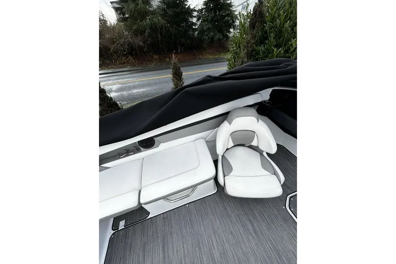 Slide: The Image of 2021 Four Winns HD2 OB boat interior with white seating and gray flooring. - 13