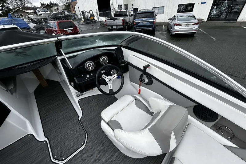 Slide: The Image of 2021 Four Winns HD2 OB boat interior with steering wheel and dashboard controls. - 17