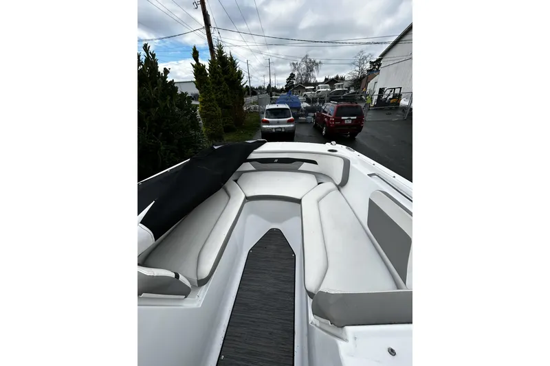 Slide: The Image of 2021 Four Winns HD2 OB boat with sleek seating, parked outdoors. - 21