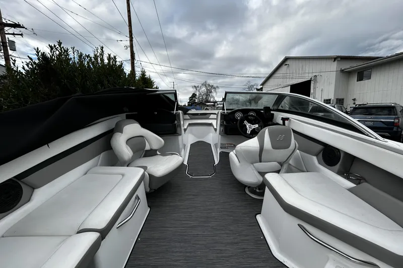 Slide: The Image of 2021 Four Winns HD2 OB boat interior with white seating and modern dashboard. - 23