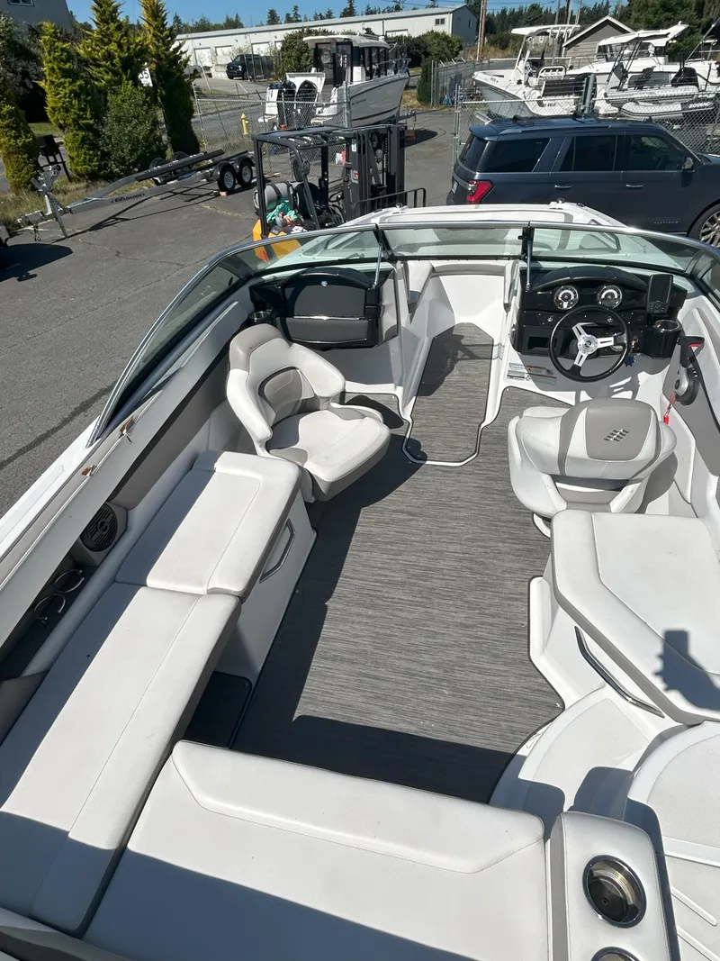 Slide: The Image of 2021 Four Winns HD2 OB boat interior with white seating and modern dashboard. - 5
